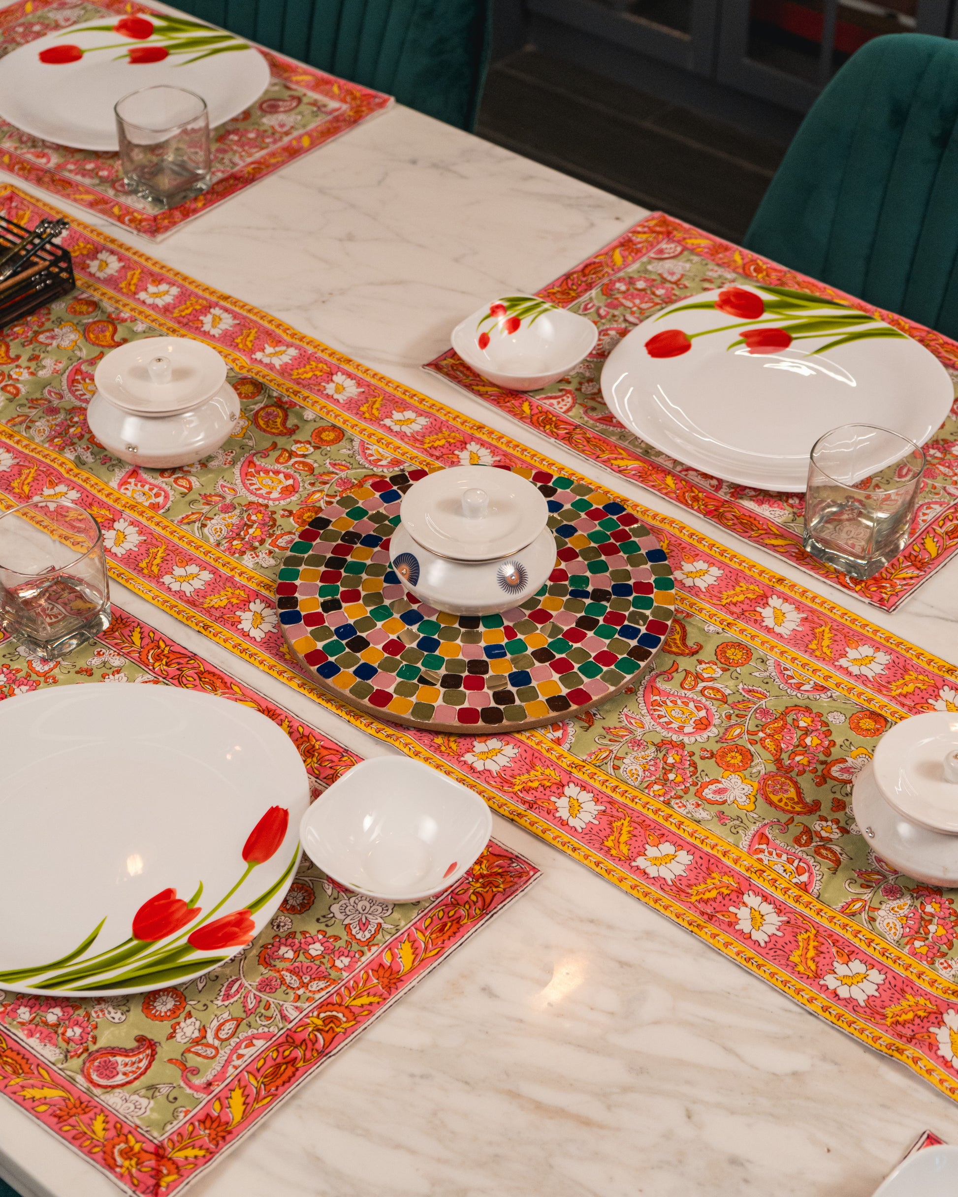 Rang Chowk Jaipur Block Print Cotton Table Runner styled on a dining table with warm and colourful décor accents.
